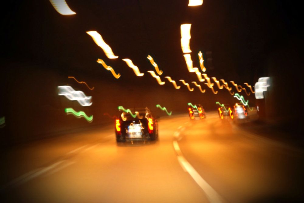 Blurred photo of cars driving in a tunnel